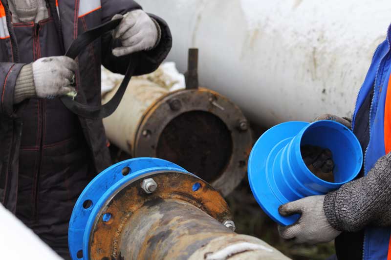 CIPP pipe lining - Cure for damaged pipes. Workers install a cured-in-place pipe (CIPP) renewal systems